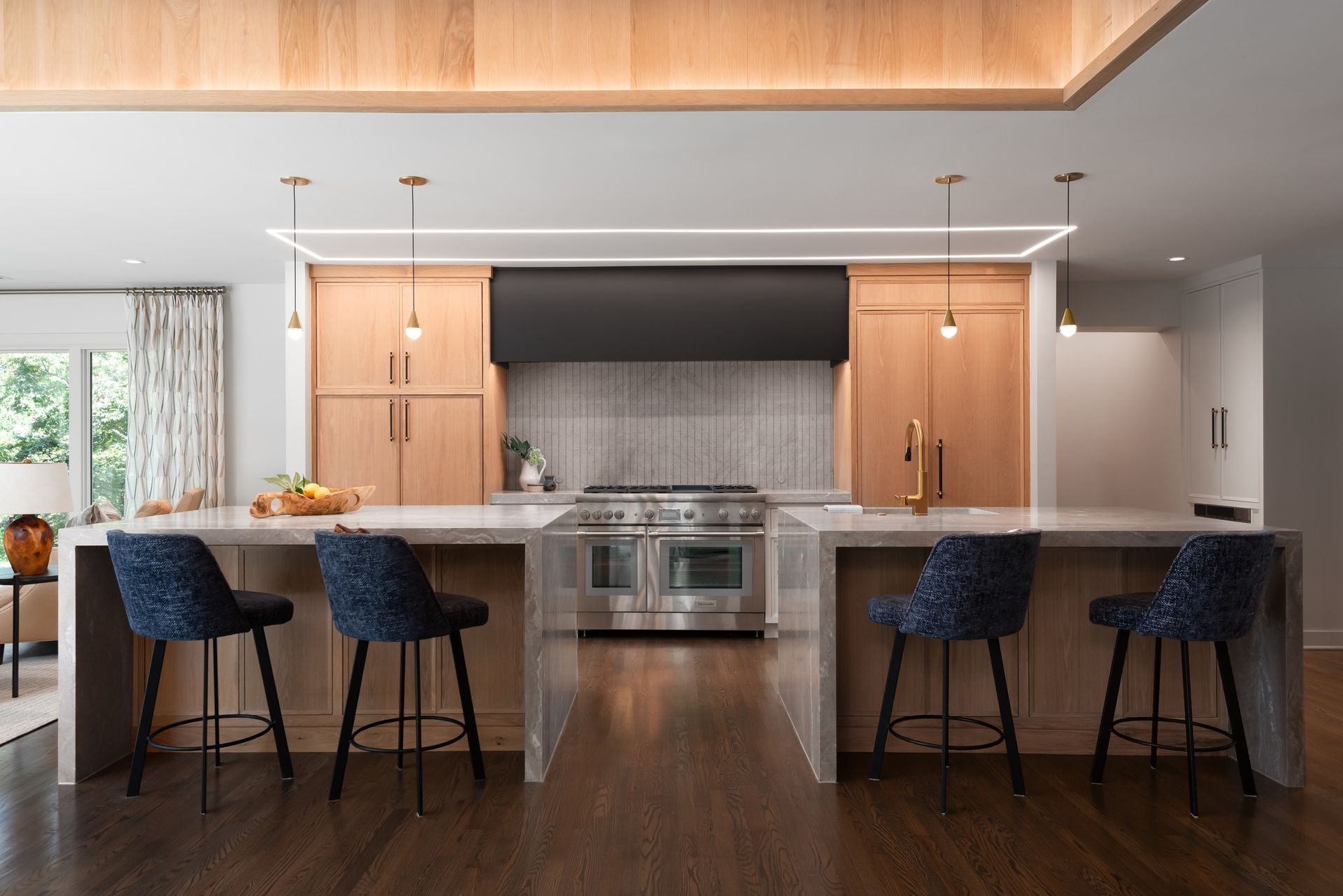 Electrician in a blue hard hat and safety glasses working on a control panel.