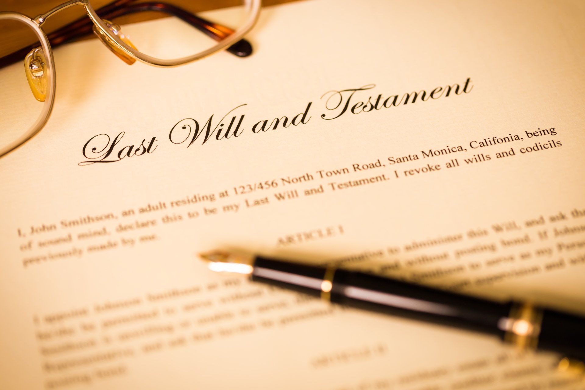 A pen is sitting on top of a last will and testament