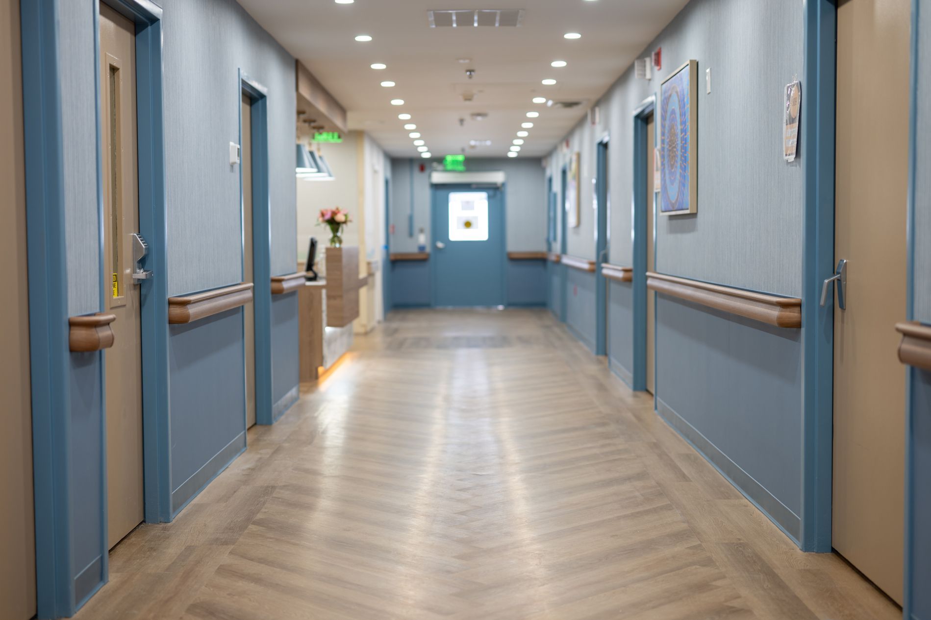 Poplar Hill hallway with blue walls and wooden floors.