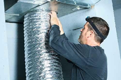 Man Working In Duct In Room - Kerrville, TX – Steamatic