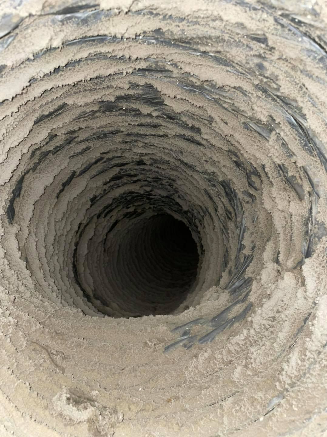 A close up of a hole in the ground covered in dirt.