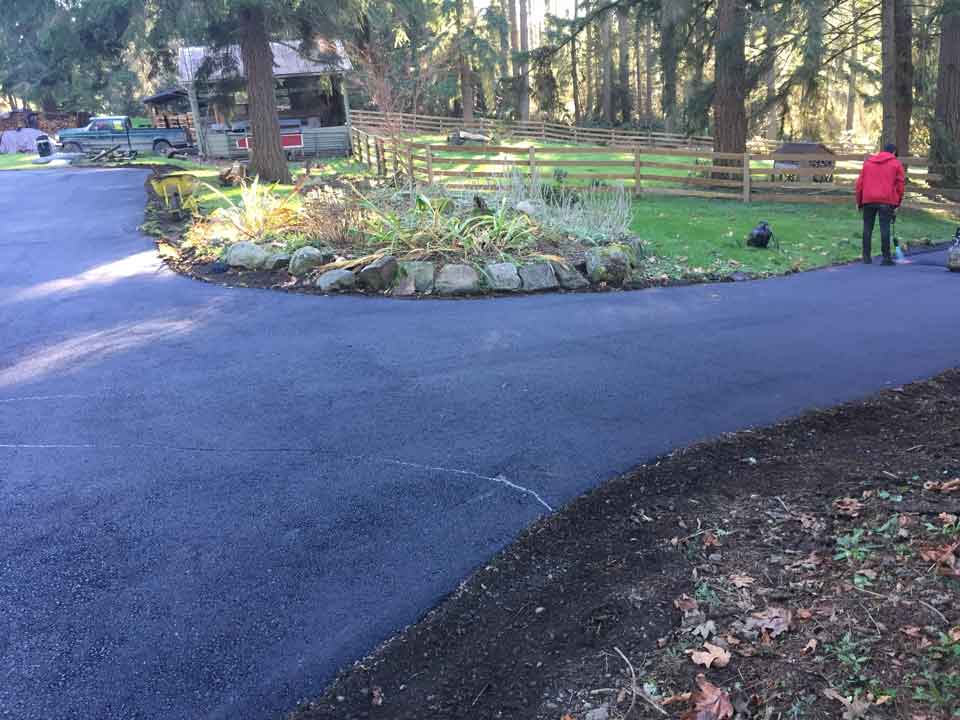 Man Watering Asphalt – Acme Paving & Seal Coating, Inc. – Kent, WA