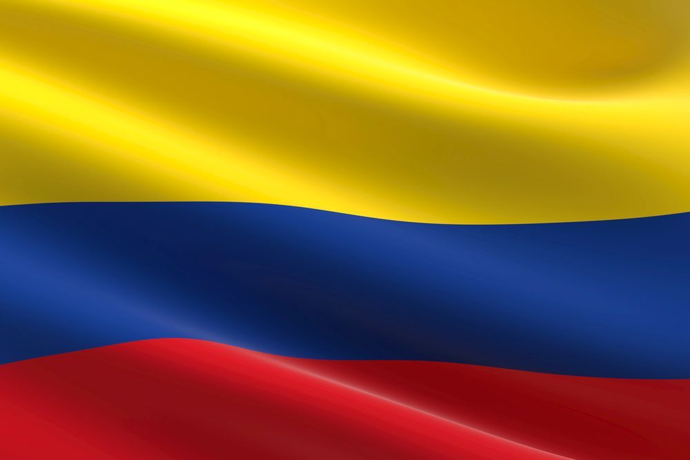 Bandera de Colombia: franjas horizontales amarillas, azules y rojas ondeando.
