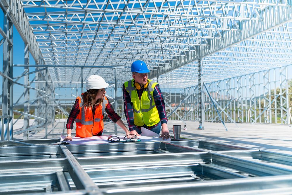 Professional Workers Calculating Plans for Steel Frames