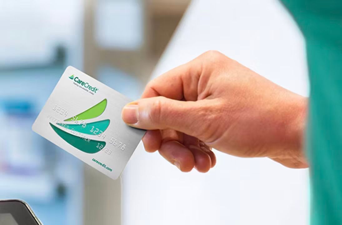 A person is holding a credit card in their hand.