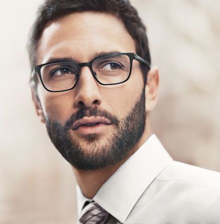 A man with a beard wearing glasses and a tie