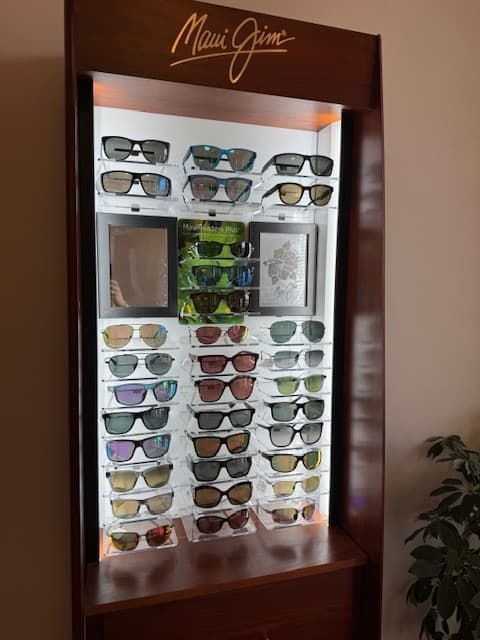 A display case filled with many different types of sunglasses