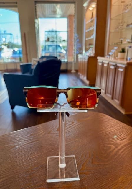 A pair of sunglasses sitting on top of a wooden table.