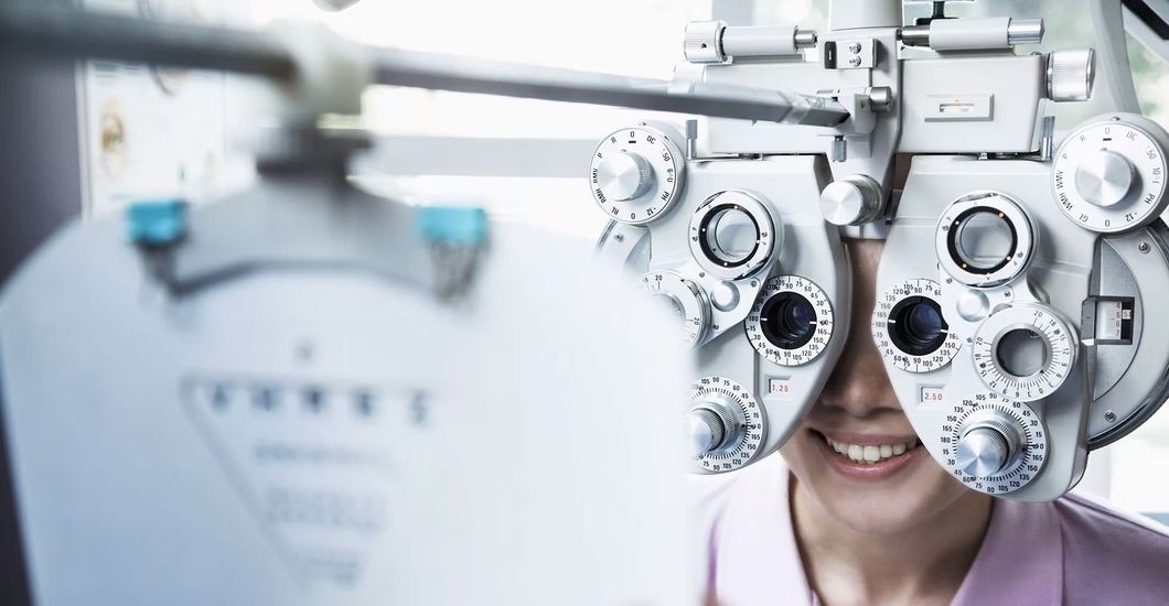 A woman is getting her eyes checked by an ophthalmologist.