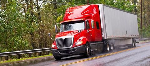 Semi Truck Commercial Insurance — Modern Red Glossy Semi Truck Trail in Corrales, NM