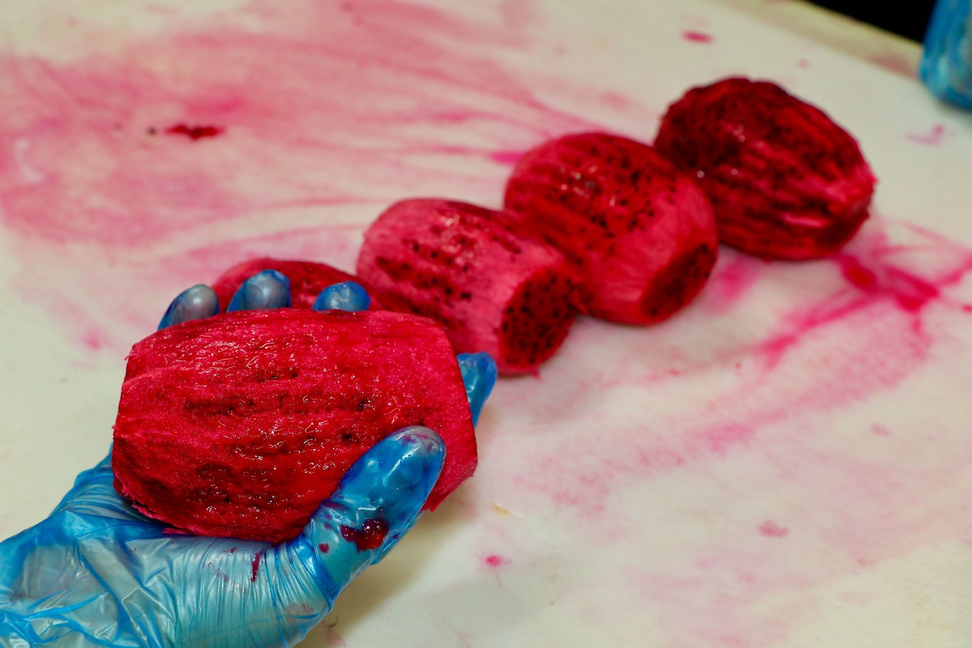 A Person is Holding a Piece of Red Fruit in Their Hand — Mareeba Golden Dried Mangoes in Mareeba, QLD