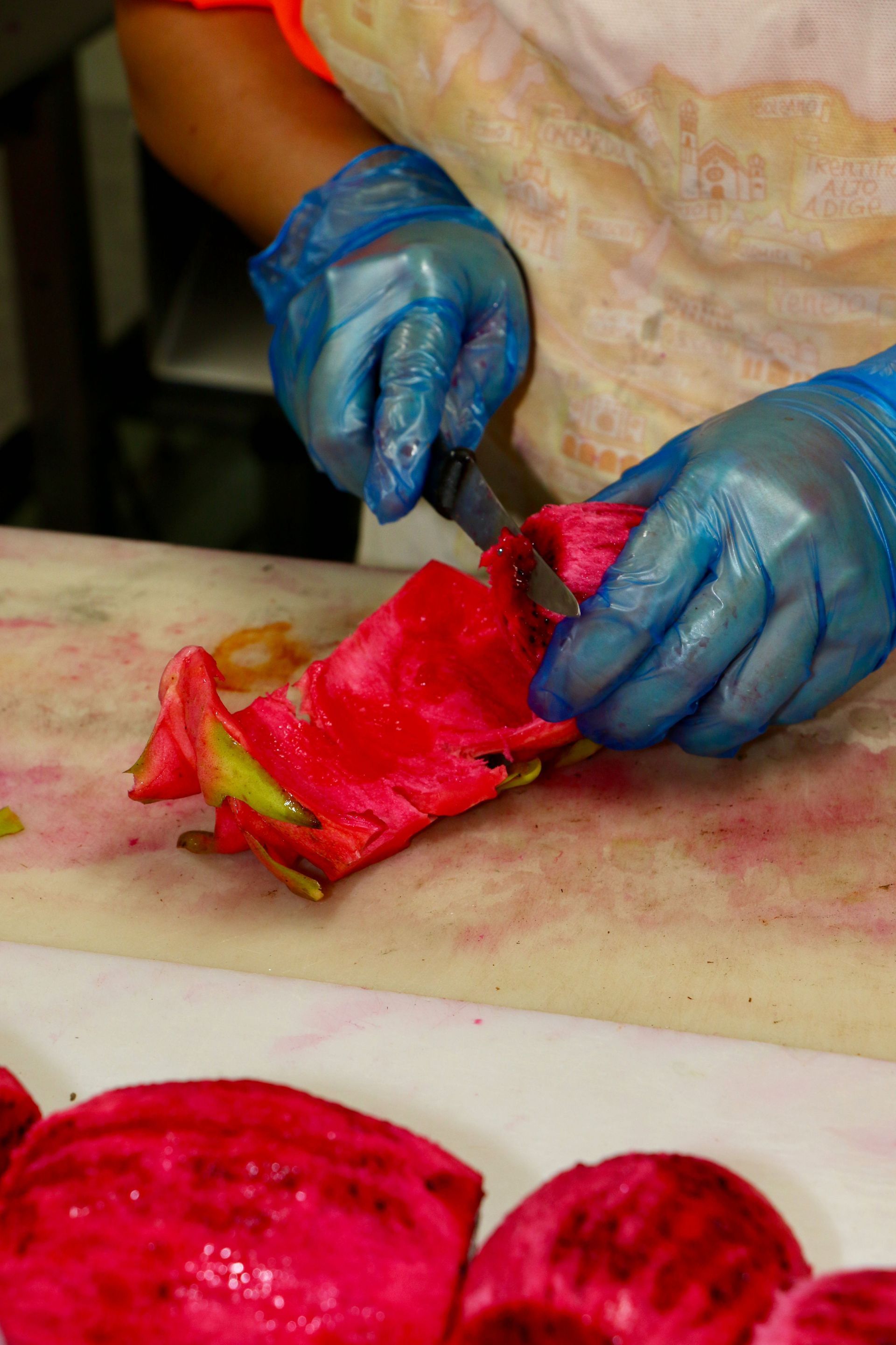 A Person is Cutting a Dragon Fruit on a Cutting Board — Mareeba Golden Dried Mangoes in Mareeba, QLD