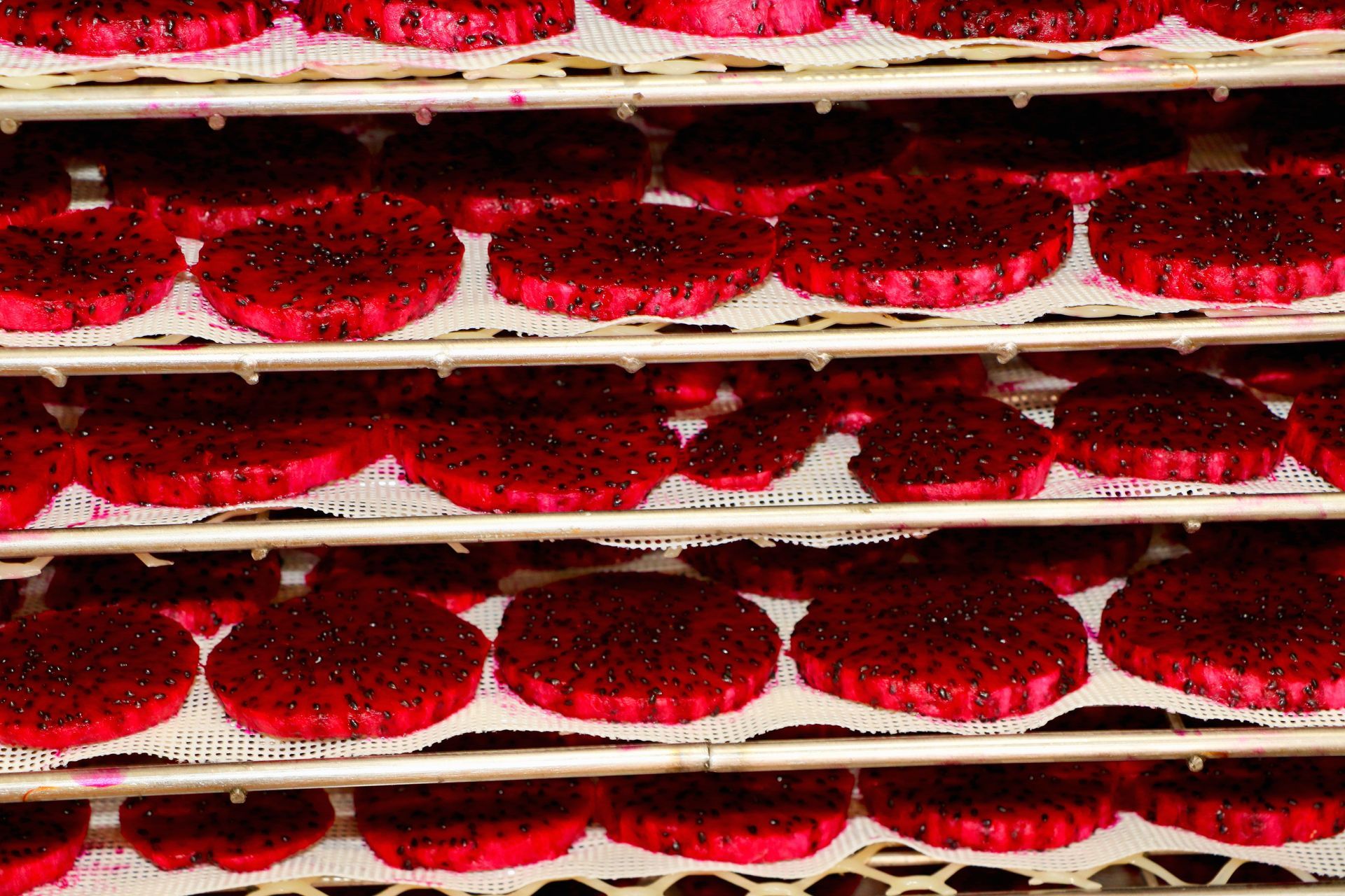 A Plate of Dried Fruit Next to a Bag of Dried Fruit — Mareeba Golden Dried Mangoes in Mareeba, QLD