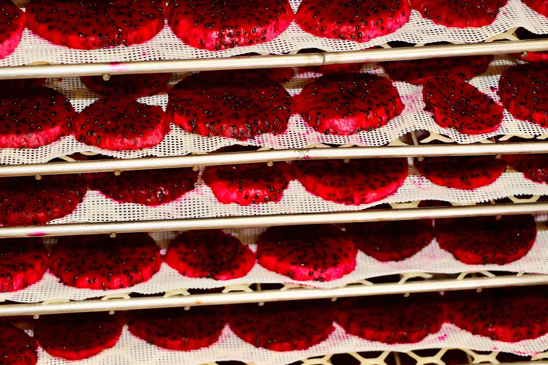 A bunch of red cookies are sitting on a shelf