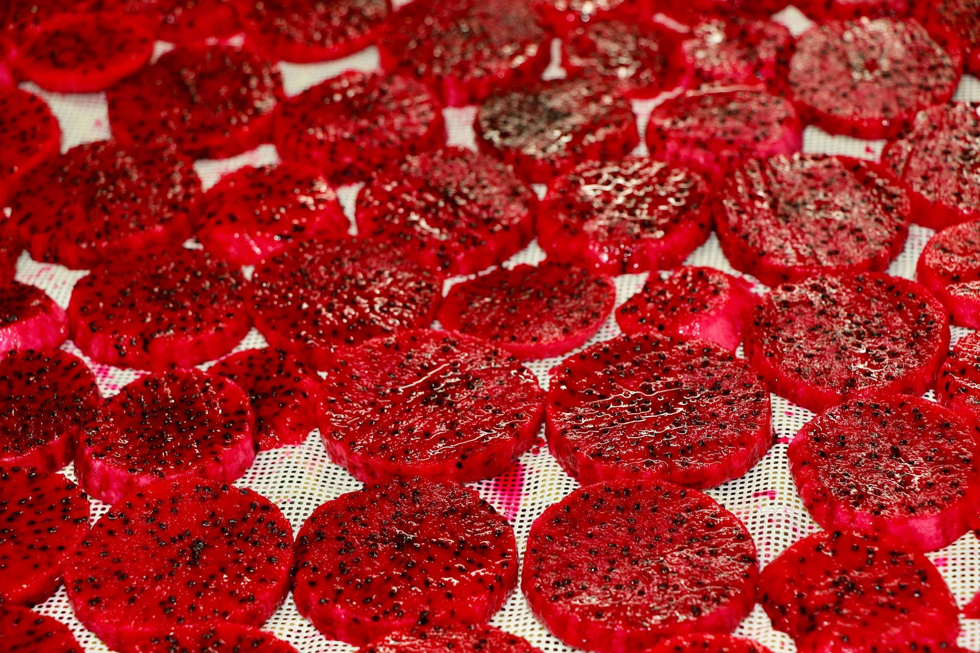 A Bunch of Red Slices of Dragon Fruit Are Sitting on a Table — Mareeba Golden Dried Mangoes in Mareeba, QLD