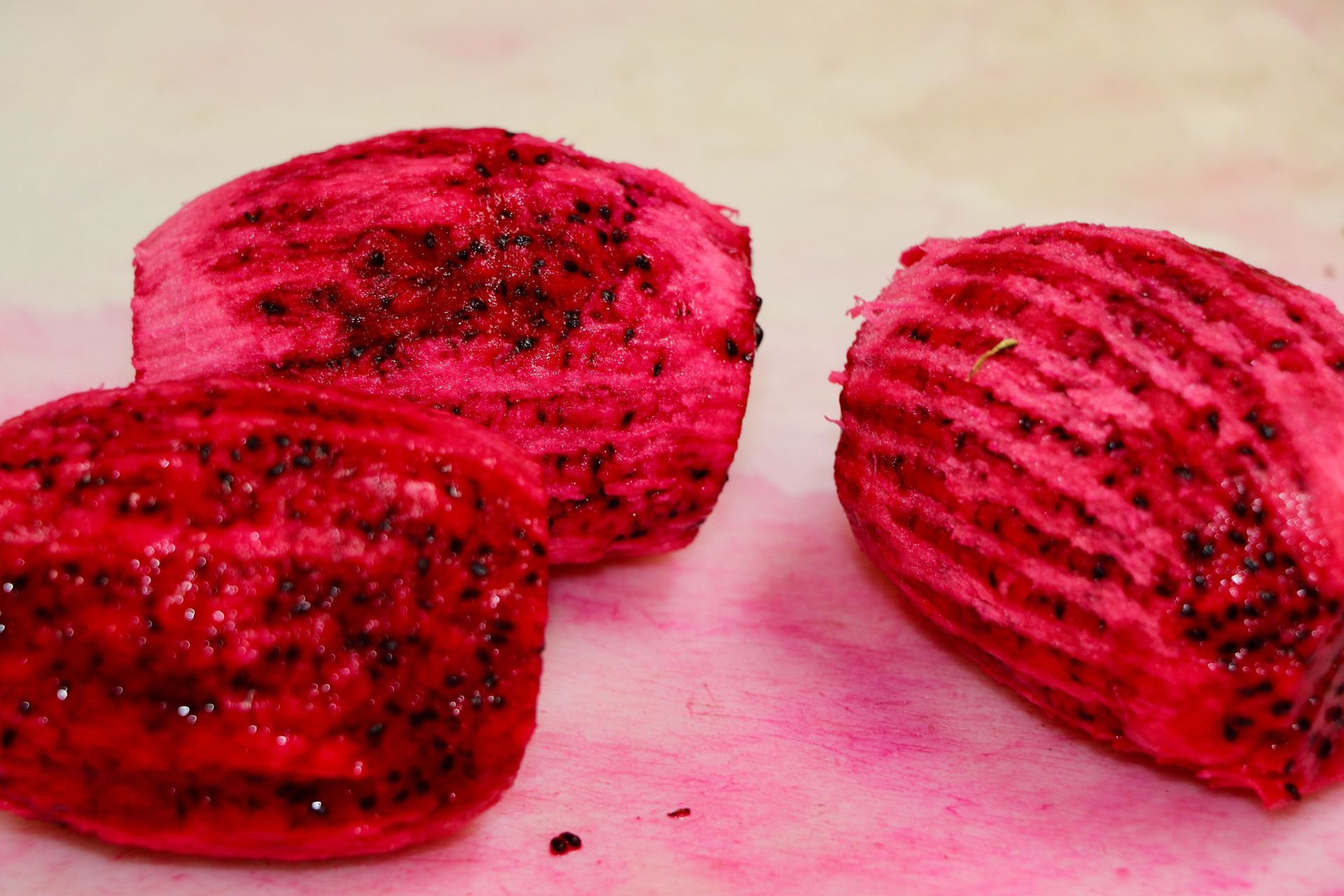 Three Pieces of Red Fruit Are Sitting on a Table — Mareeba Golden Dried Mangoes in Mareeba, QLD
