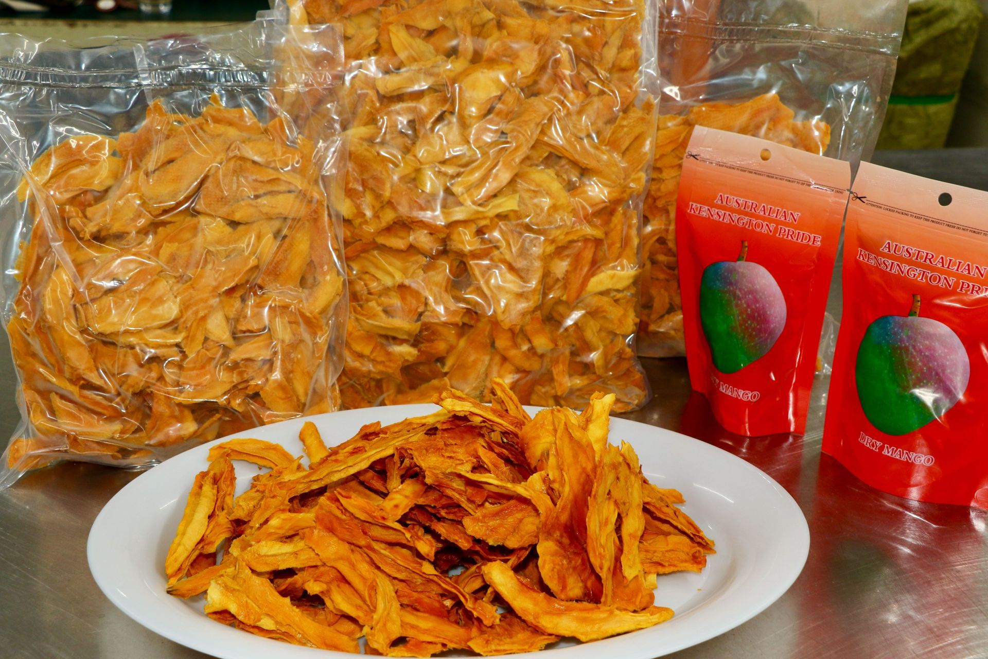 A Mango Slices Next to Bags of Dried Mango Slices — Mareeba Golden Dried Mangoes in Mareeba, QLD