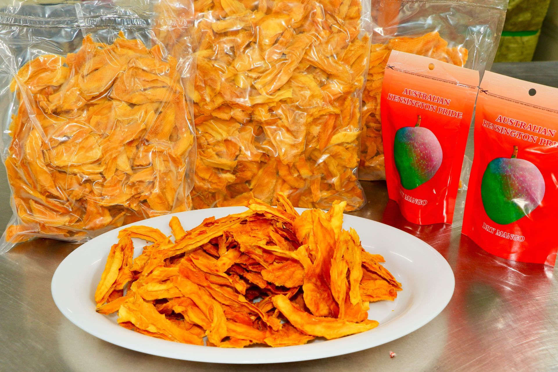 A Mango Slices Next to Bags of Dried Mango Slices — Mareeba Golden Dried Mangoes in Mareeba, QLD