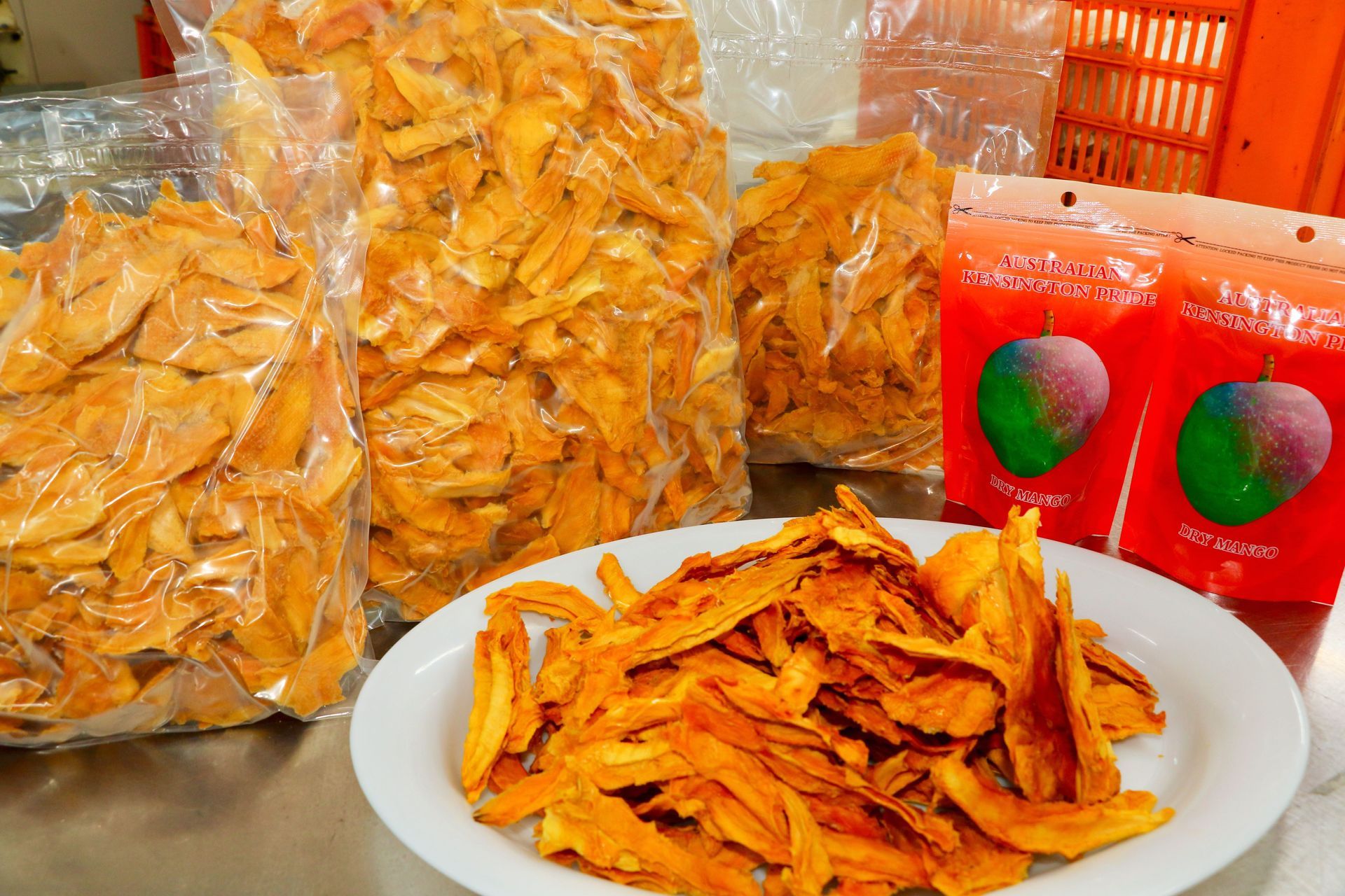 A White Plate Topped With Dried Mango Slices — Mareeba Golden Dried Mangoes in Mareeba, QLD