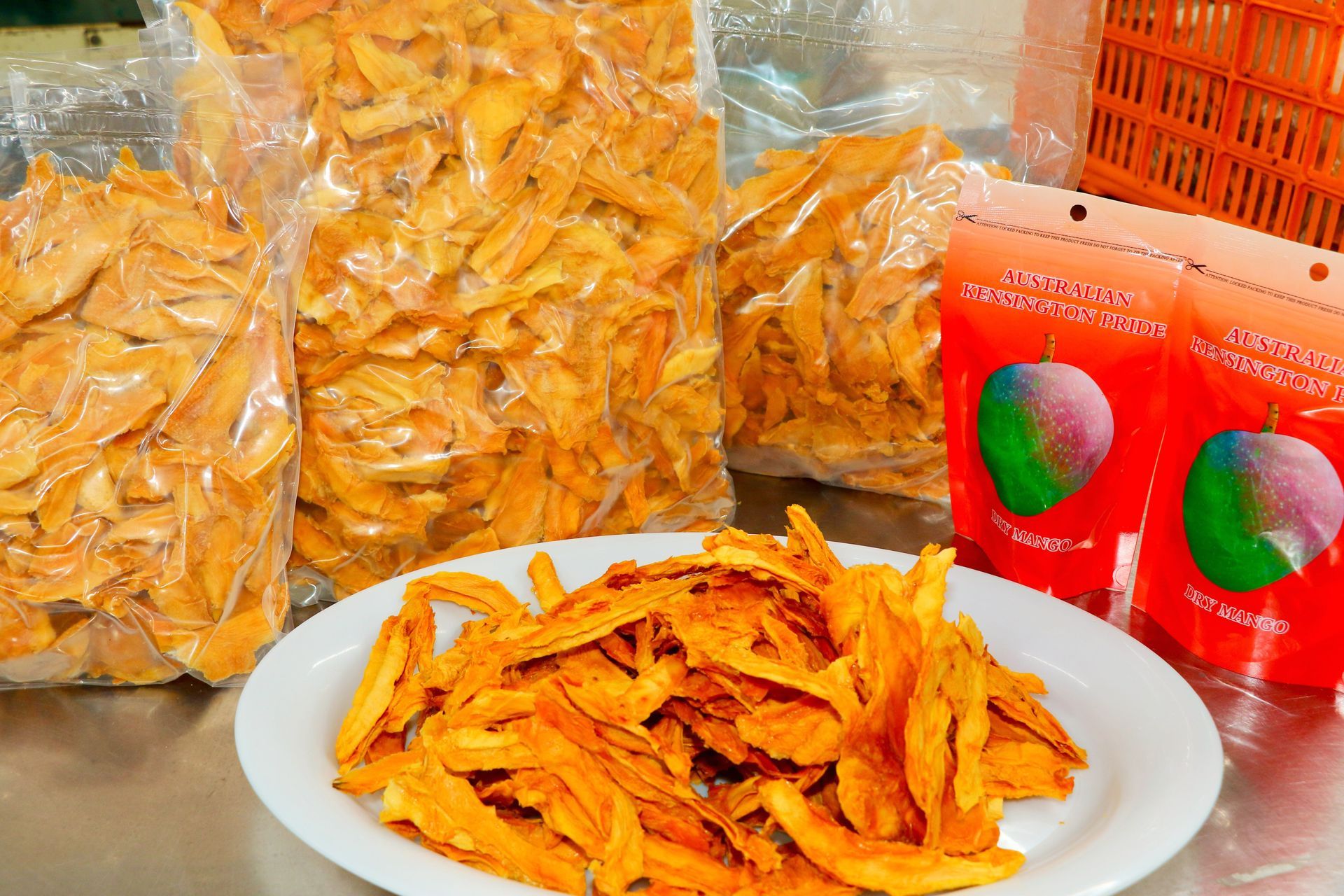 A Plate of Food is Sitting on a Table Next to Bags of Food — Mareeba Golden Dried Mangoes in Mareeba, QLD