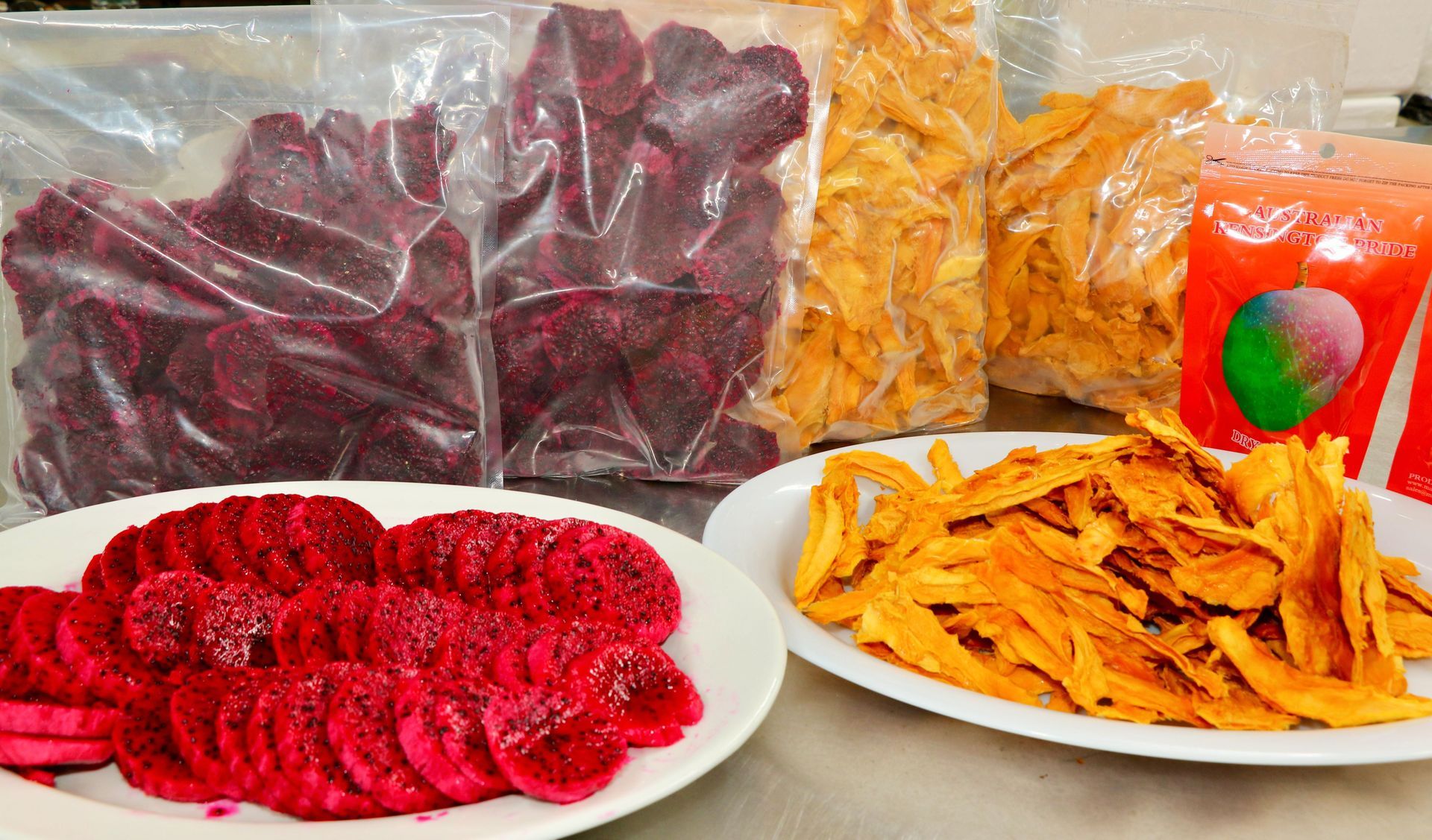 A Table Topped With Plates of Food and Bags of Food — Mareeba Golden Dried Mangoes in Mareeba, QLD