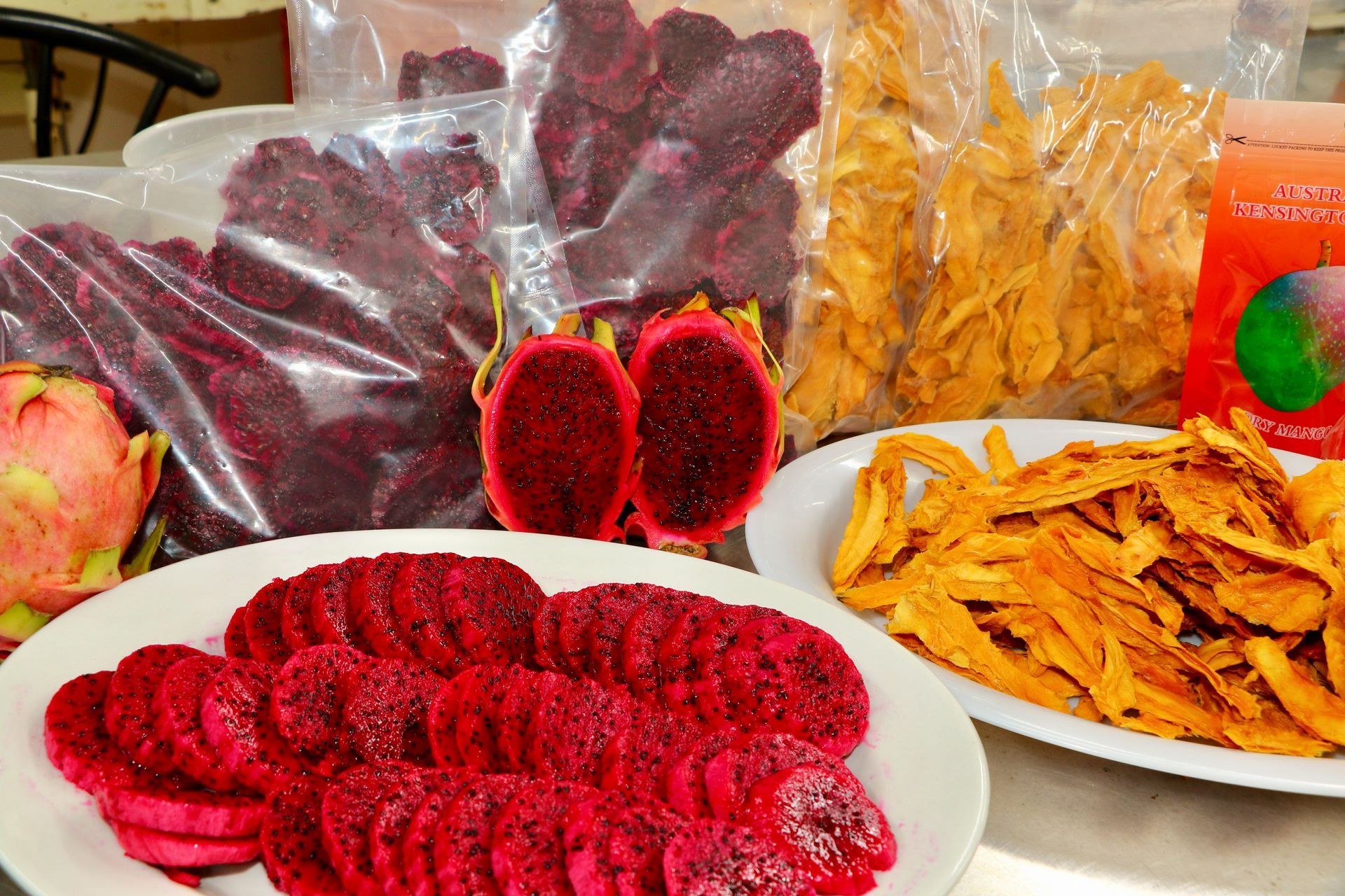 A Table Topped With Plates of Food and a Bag of Dried Fruit — Mareeba Golden Dried Mangoes in Mareeba, QLD