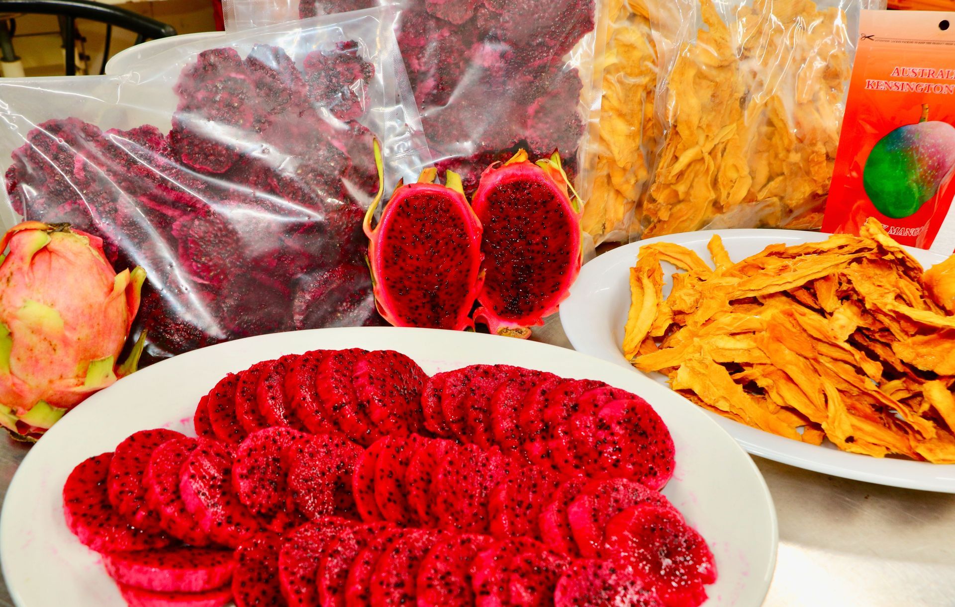 A Table Topped With Plates of Food and a Bag of Dried Fruit — Mareeba Golden Dried Mangoes in Mareeba, QLD