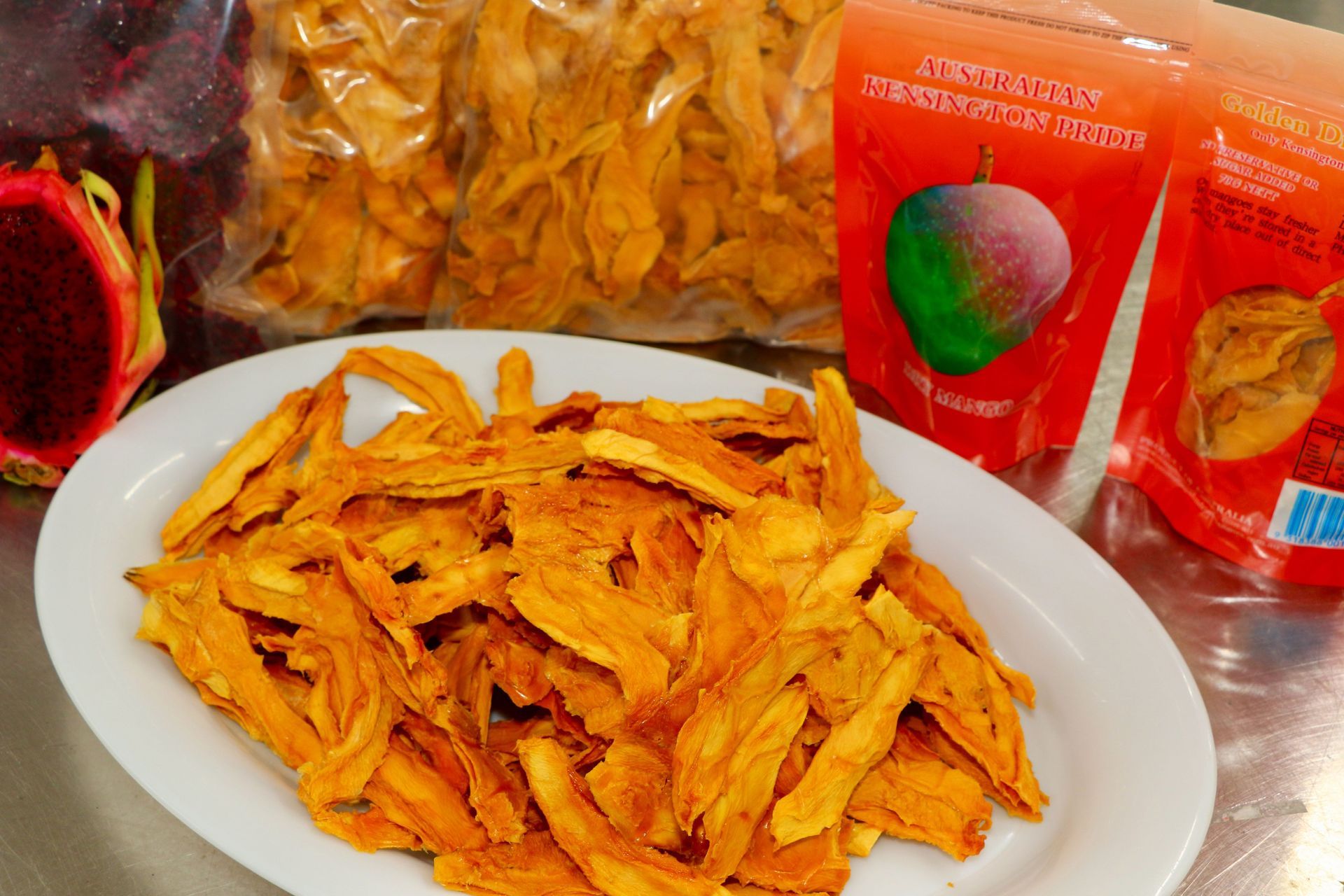 A Plate of Dried Fruit Next to a Bag of Dried Fruit — Mareeba Golden Dried Mangoes in Mareeba, QLD