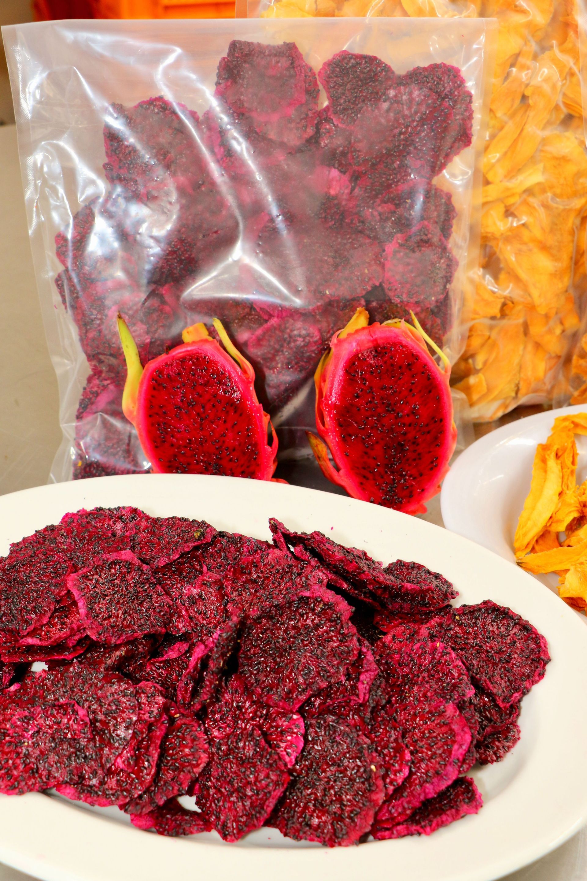 There Are Two Plates of Food and a Bag of Food on the Table — Mareeba Golden Dried Mangoes in Mareeba, QLD