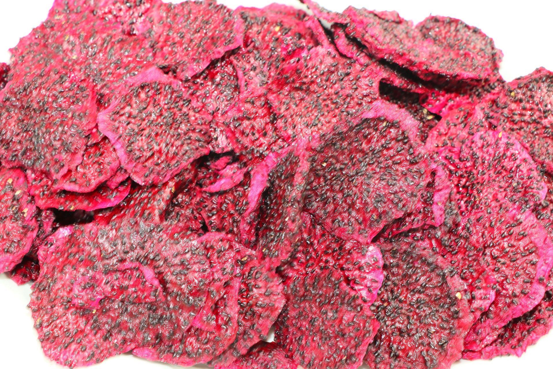 A Pile of Dried Dragon Fruit Chips on a White Background — Mareeba Golden Dried Mangoes in Mareeba, QLD
