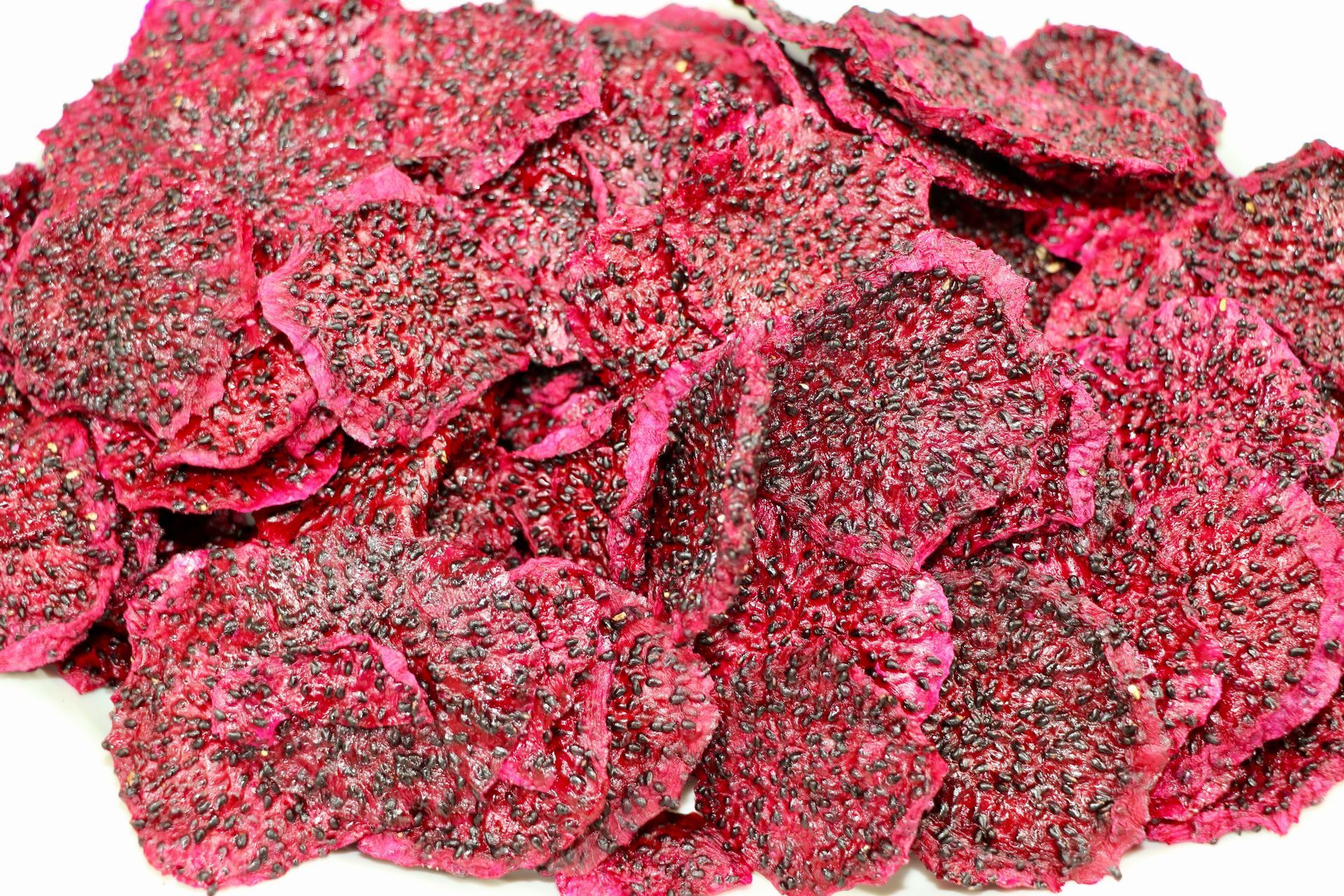 A Pile of Dried Dragon Fruit Chips on a White Background — Mareeba Golden Dried Mangoes in Mareeba, QLD