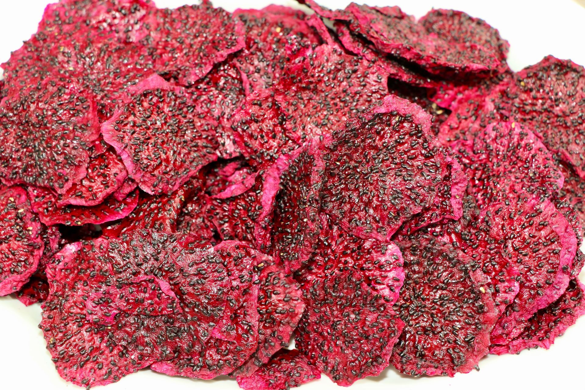 A Pile of Dried Dragon Fruit Chips on a White Plate — Mareeba Golden Dried Mangoes in Mareeba, QLD
