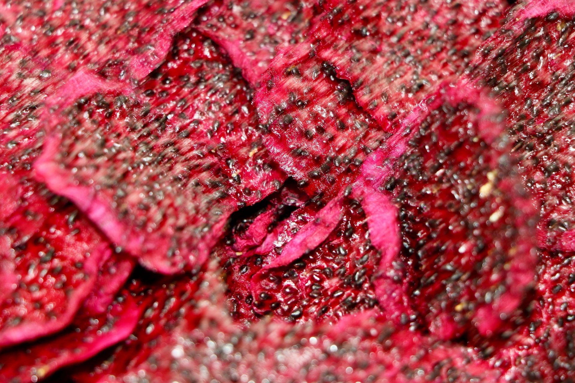 Three Pieces of Red Fruit Are Sitting on a Table — Mareeba Golden Dried Mangoes in Mareeba, QLD