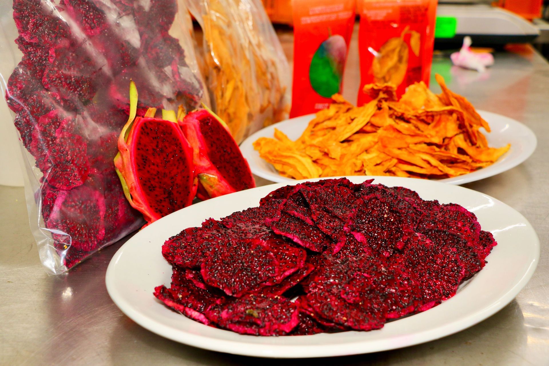 A Plate of Dried Fruit Next to a Bag of Dried Fruit — Mareeba Golden Dried Mangoes in Mareeba, QLD