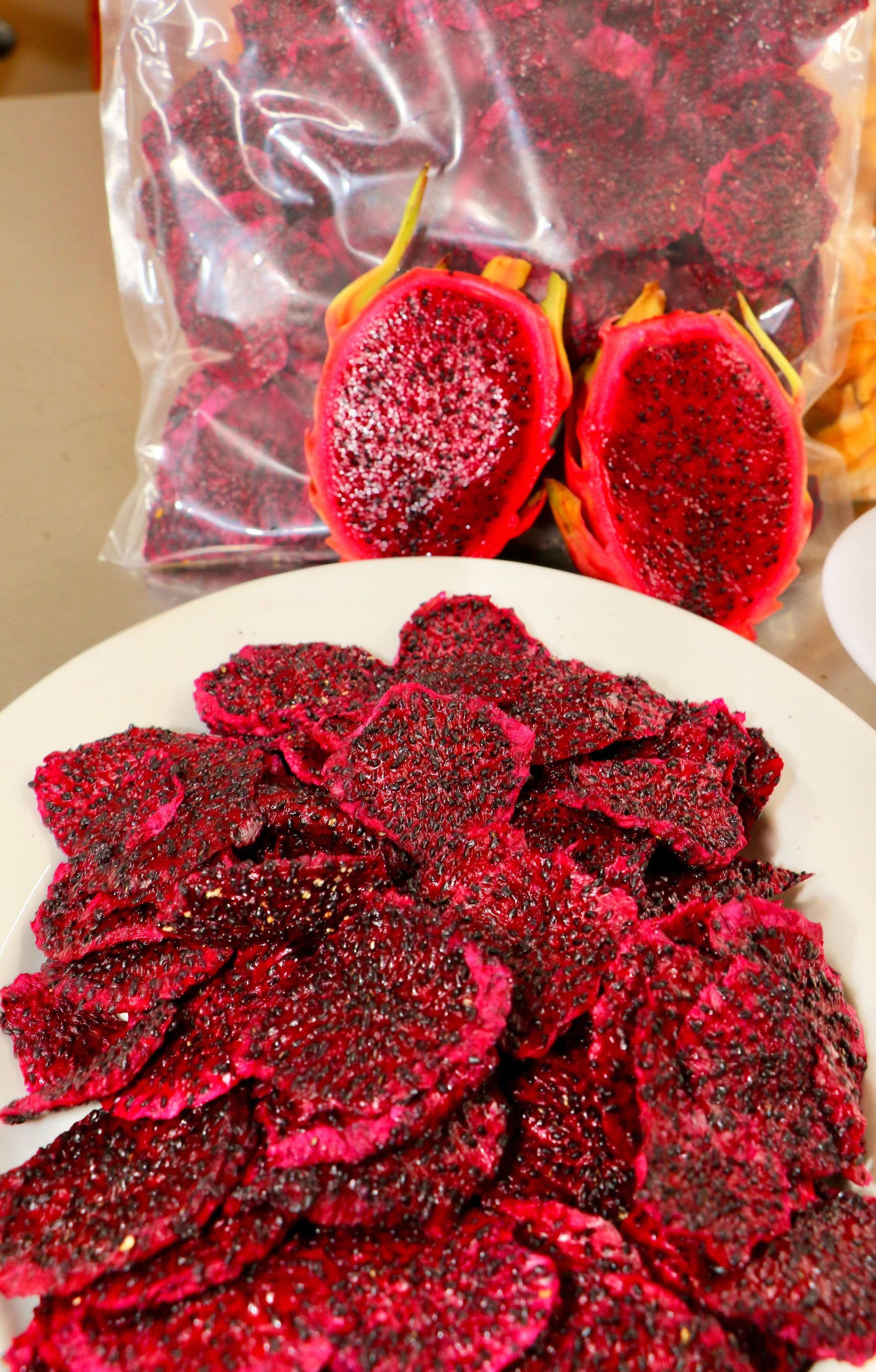 A Plate of Dried Dragon Fruit Next to a Bag of Dried Dragon Fruit — Mareeba Golden Dried Mangoes in Mareeba, QLD