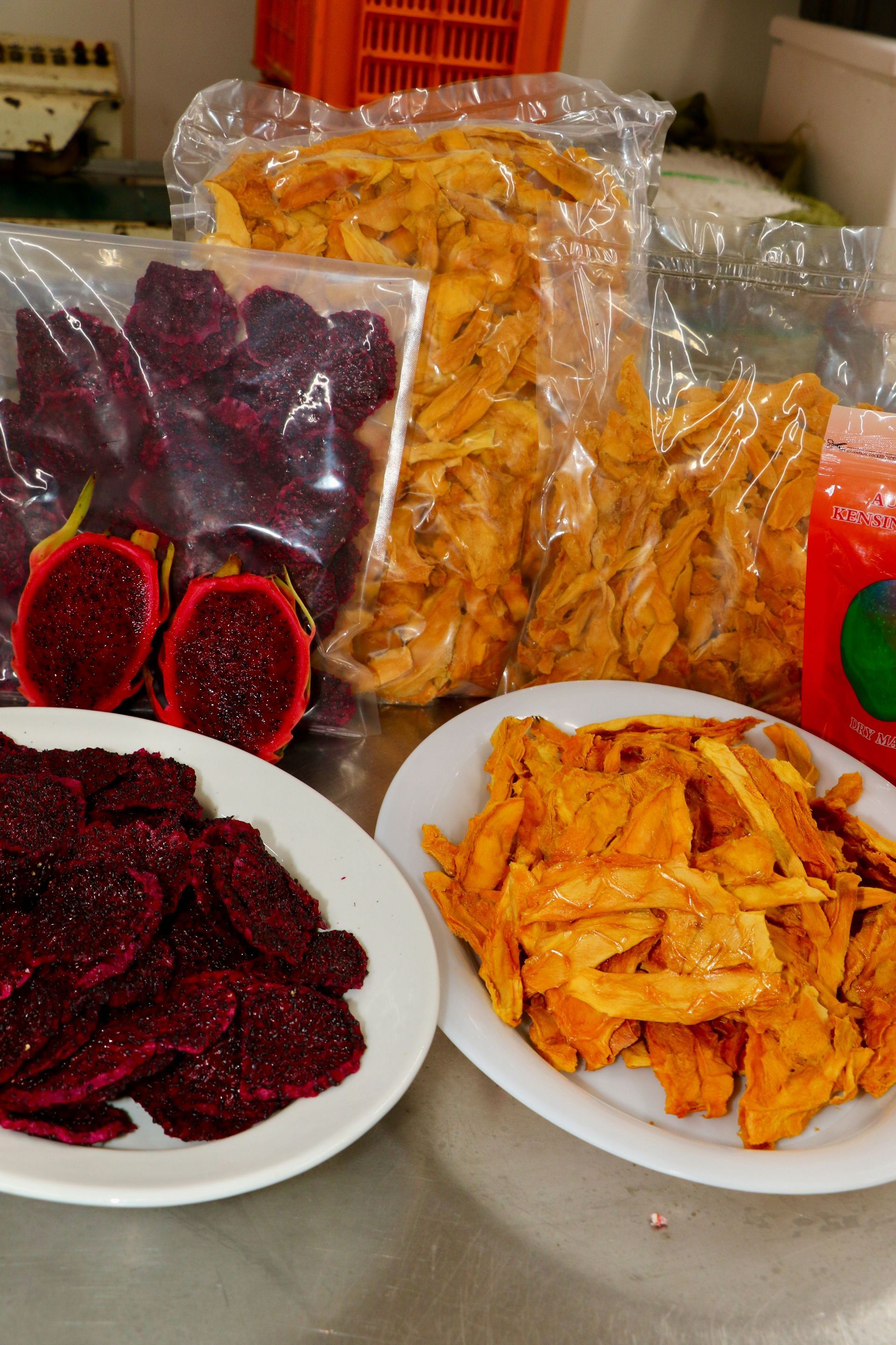 A Table Topped With Plates of Food and a Bag of Dried Fruit — Mareeba Golden Dried Mangoes in Mareeba, QLD