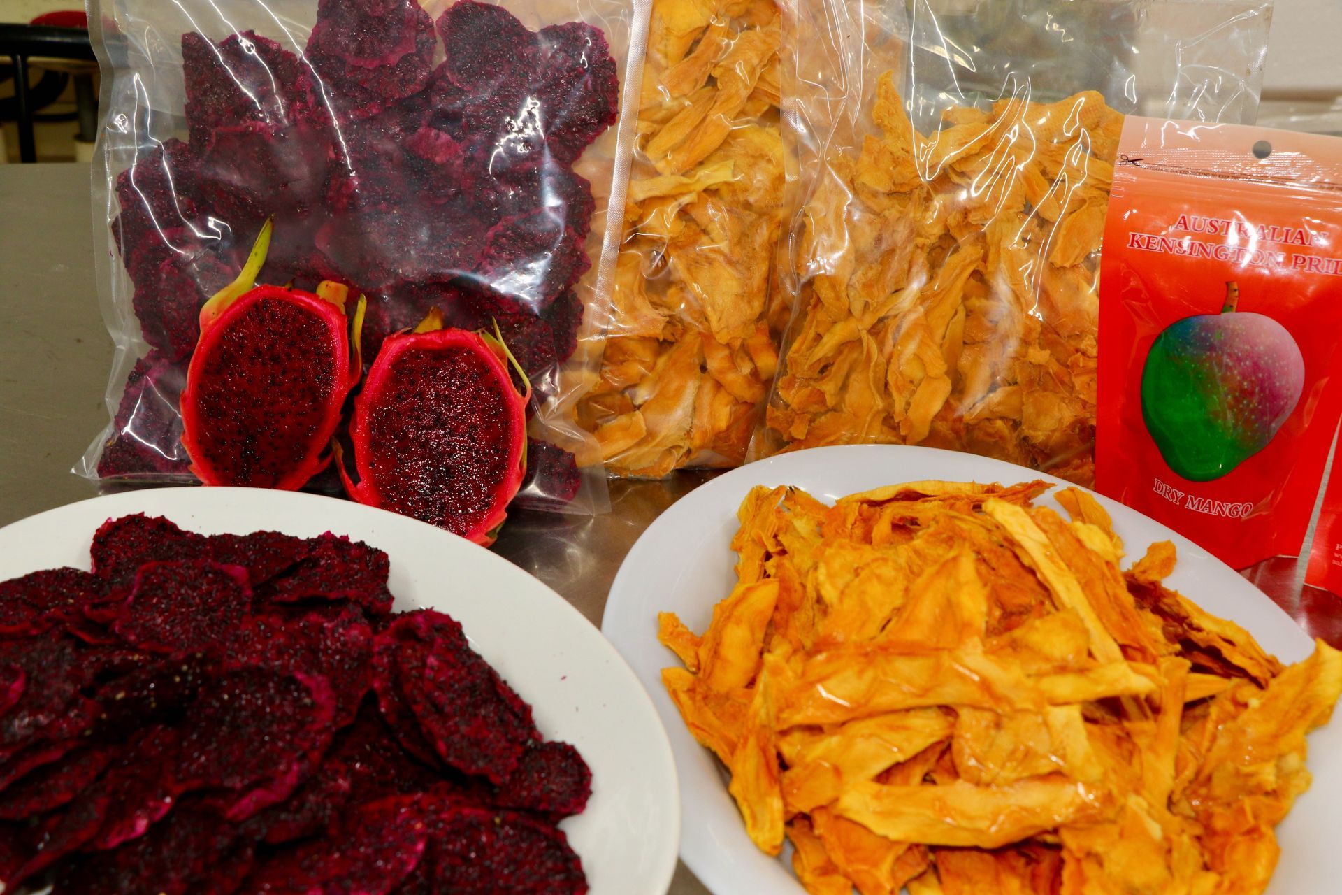 A Variety of Dried Fruits Are Sitting on Plates on a Table — Mareeba Golden Dried Mangoes in Mareeba, QLD