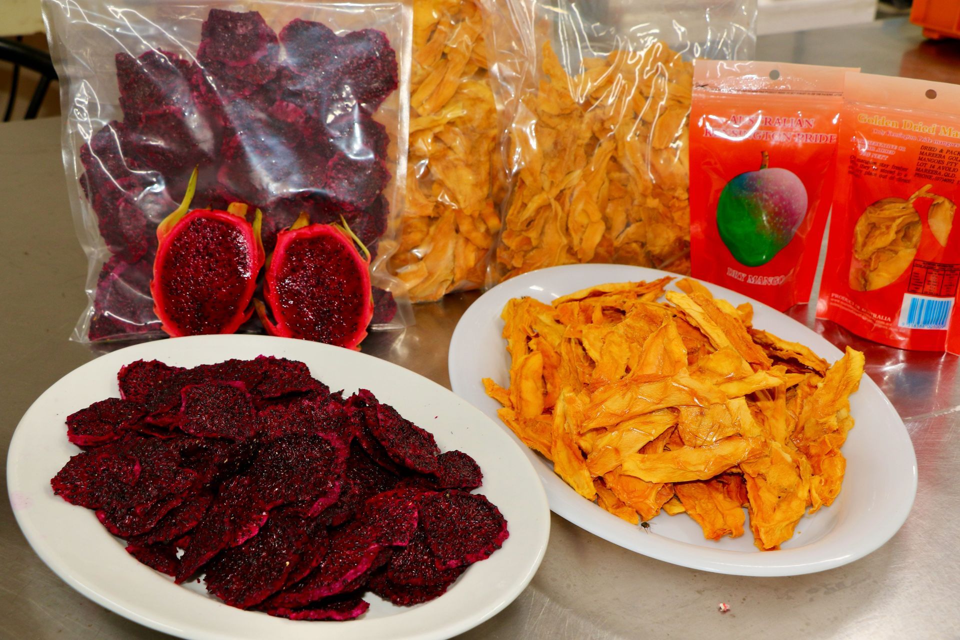A Table With Plates of Food and a Bag of Dried Fruit — Mareeba Golden Dried Mangoes in Mareeba, QLD