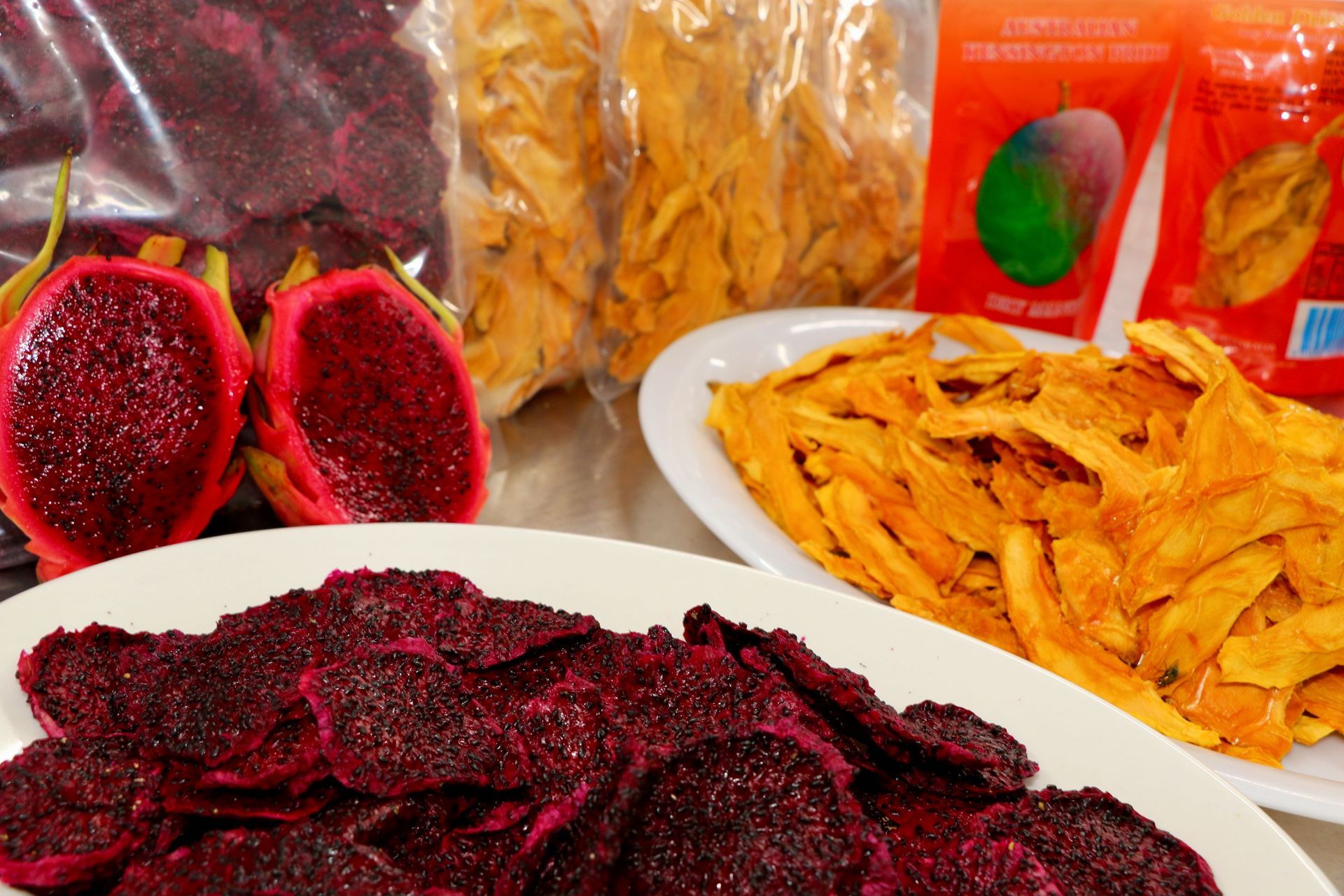 A Plate of Dried Fruit Next to a Bag of Dried Fruit — Mareeba Golden Dried Mangoes in Mareeba, QLD