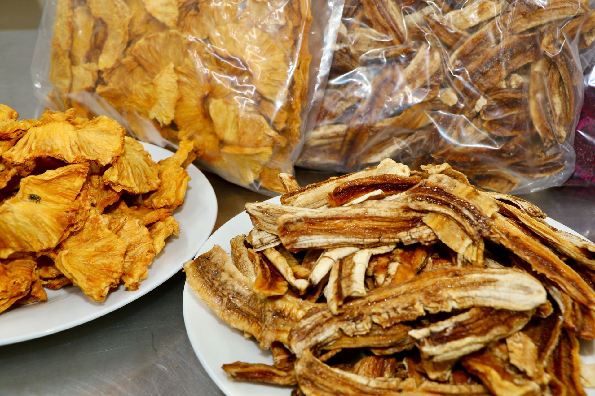 There Are Two Plates of Food and a Bag of Food on the Table — Mareeba Golden Dried Mangoes in Mareeba, QLD