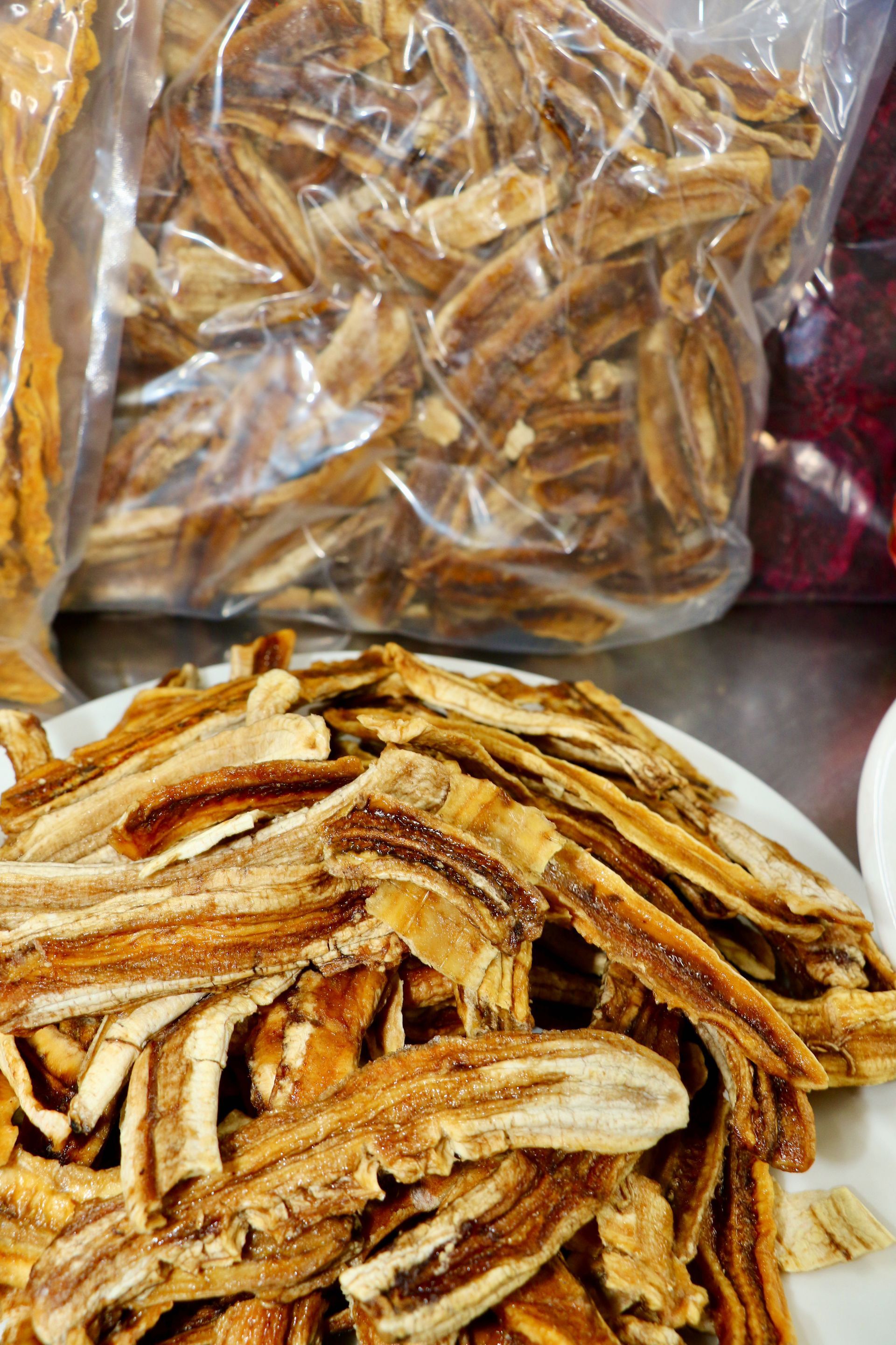 A Person Wearing Blue Gloves is Cutting a Dragon Fruit on a Table — Mareeba Golden Dried Mangoes in Mareeba, QLD