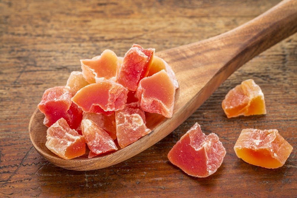 A Wooden Spoon Filled With Dried Papaya on a Wooden Table — Mareeba Golden Dried Mangoes in Gold Coast, QLD
