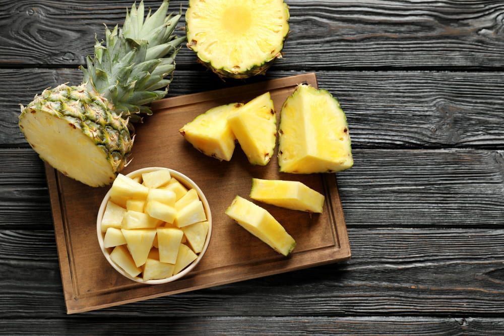 Pineapple Slices on a Wooden Cutting Board on a Wooden Table — Mareeba Golden Dried Mangoes in Townsville, QLD