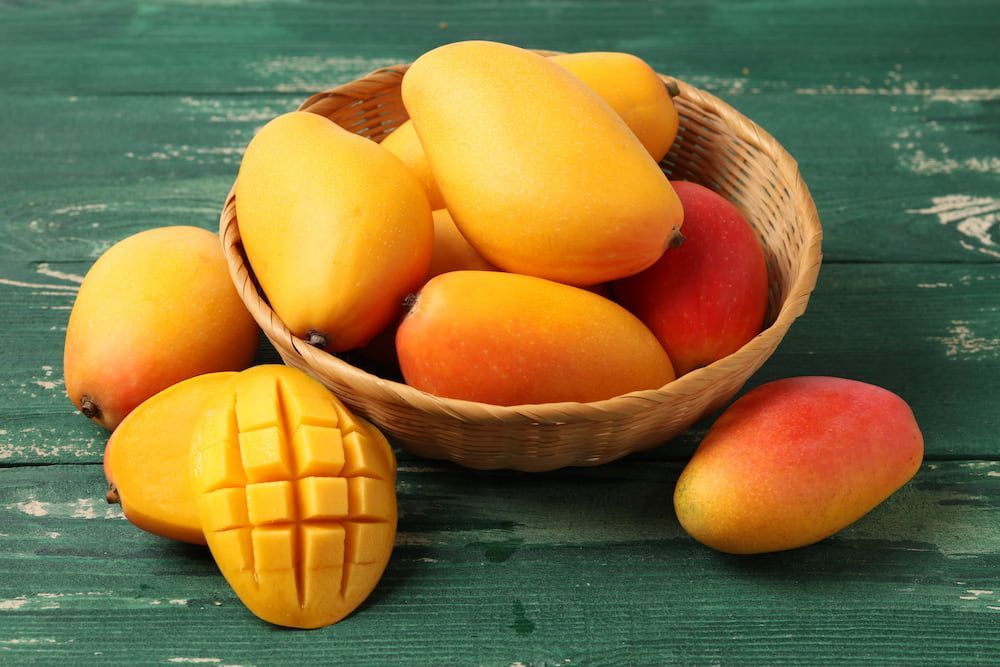 A Bowl of Dried Mango Slices on a Wooden Table — Mareeba Golden Dried Mangoes in Sunshine Coast, QLD