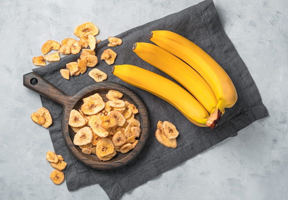 There is a Bowl of Banana Chips and Bananas on the Table — Mareeba Golden Dried Mangoes in Sunshine Coast, QLD