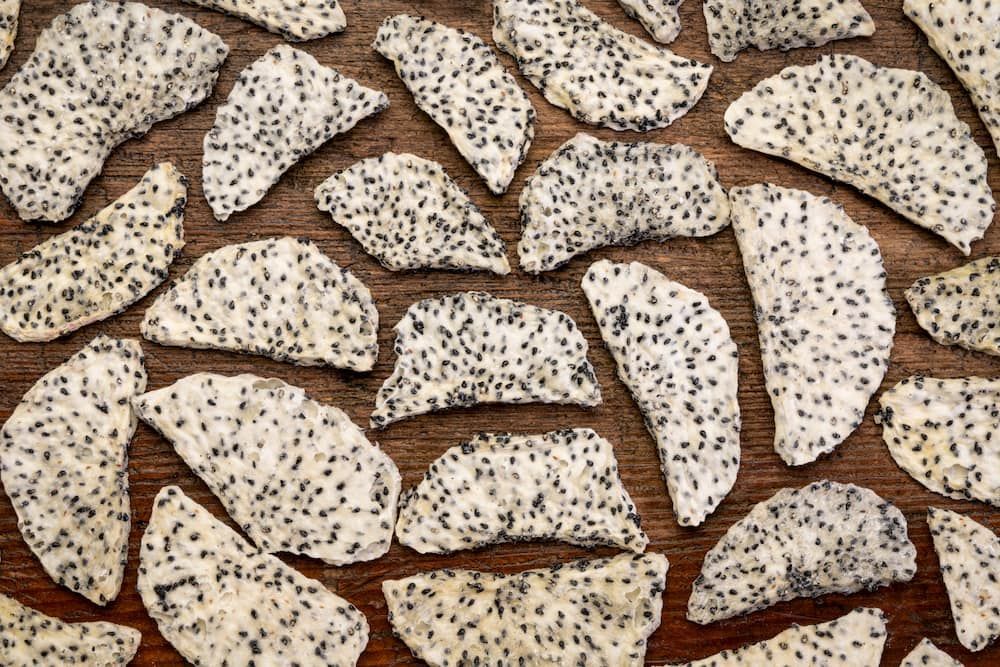 A Pile of Dried Dragon Fruit Chips on a Wooden Table — Mareeba Golden Dried Mangoes in Brisbane, QLD