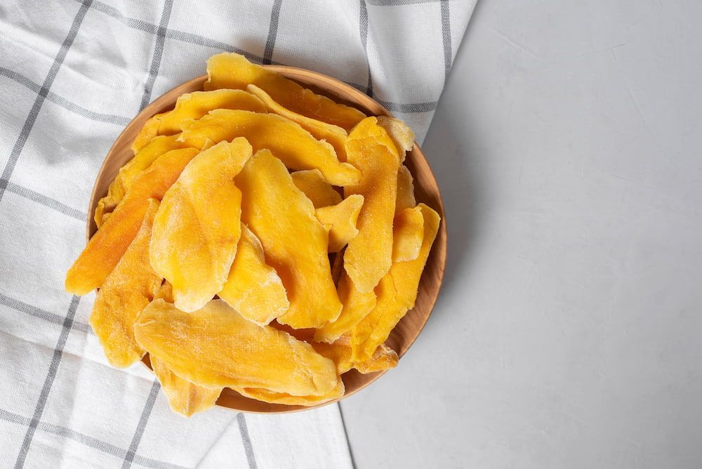 Dried Mango Slices in a Wooden Bowl on a Table — Mareeba Golden Dried Mangoes in Sunshine Coast, QLD