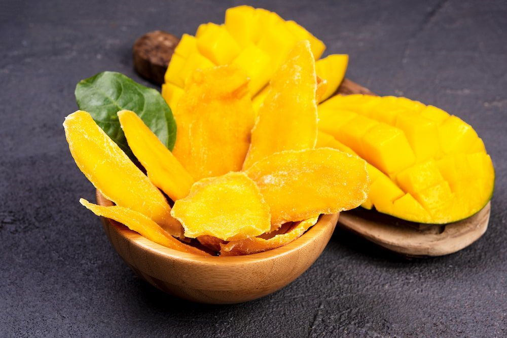 Dried Mango Slices in a Wooden Bowl on a Table — Mareeba Golden Dried Mangoes in Sunshine Coast, QLD
