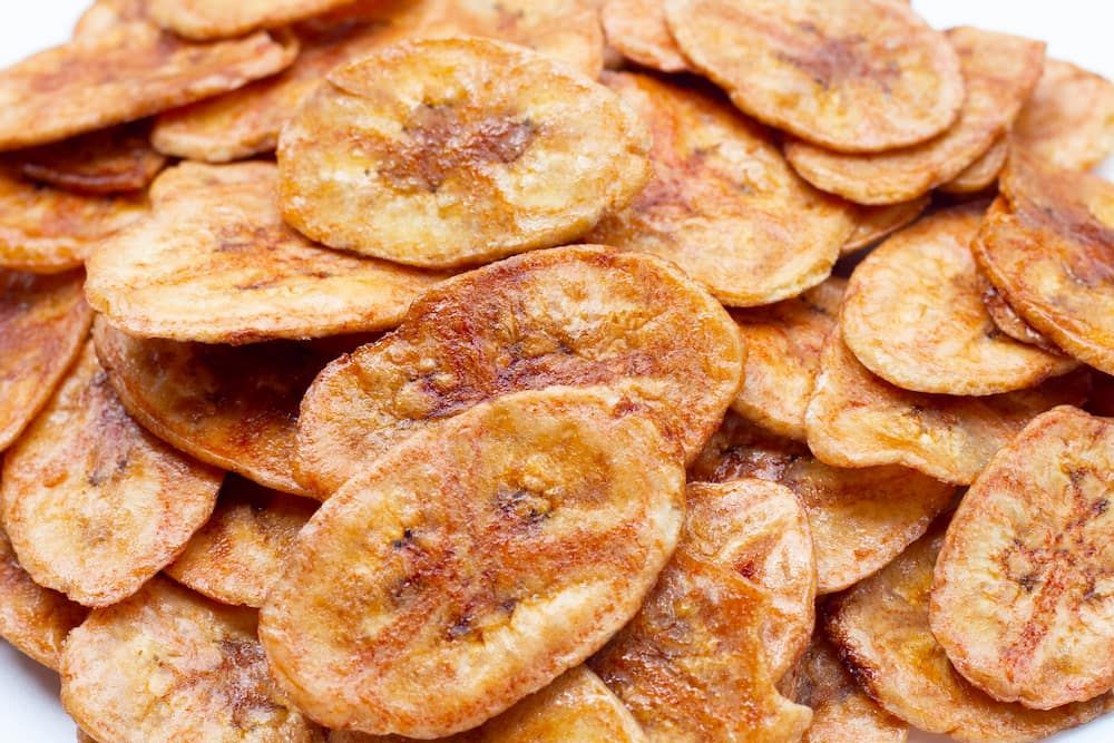 A Pile of Fried Banana Chips on a White Plate — Mareeba Golden Dried Mangoes in Brisbane, QLD
