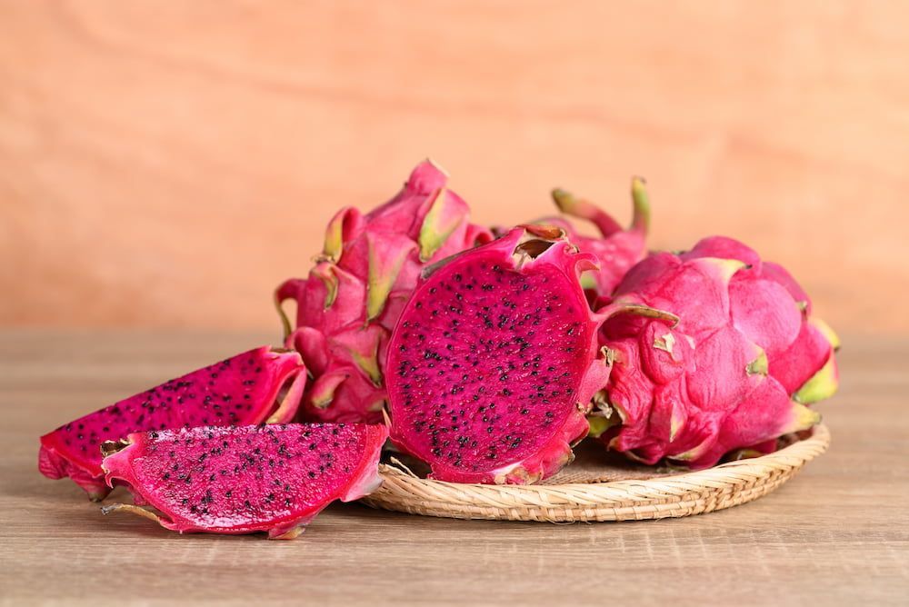 A Bunch of Dragon Fruit Sitting on Top of a Wooden Table — Mareeba Golden Dried Mangoes in Gold Coast, QLD